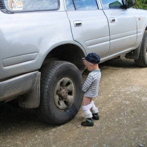 boy_peeing_on_truck_tire