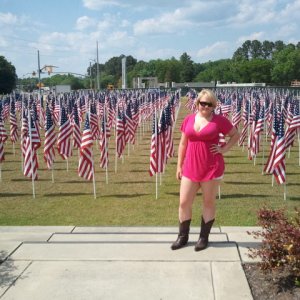 Girlfriend standing in front of field of American Flags