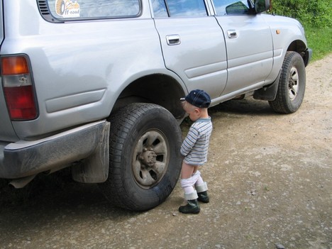 boy_peeing_on_truck_tire